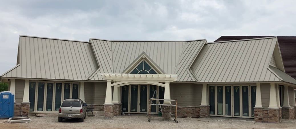 Pierce Roofing crew applying a reflective coating restoration system over a commercial low-slope roof in Green Bay, Wisconsin