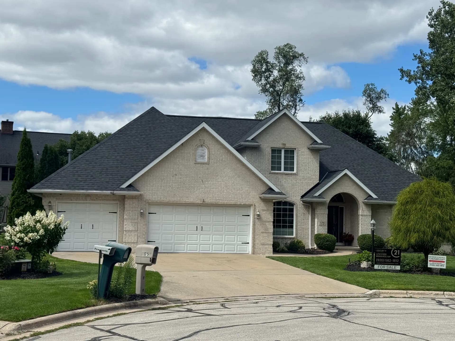 Brick two-story home with a new roof installed before sale by Pierce Roofing