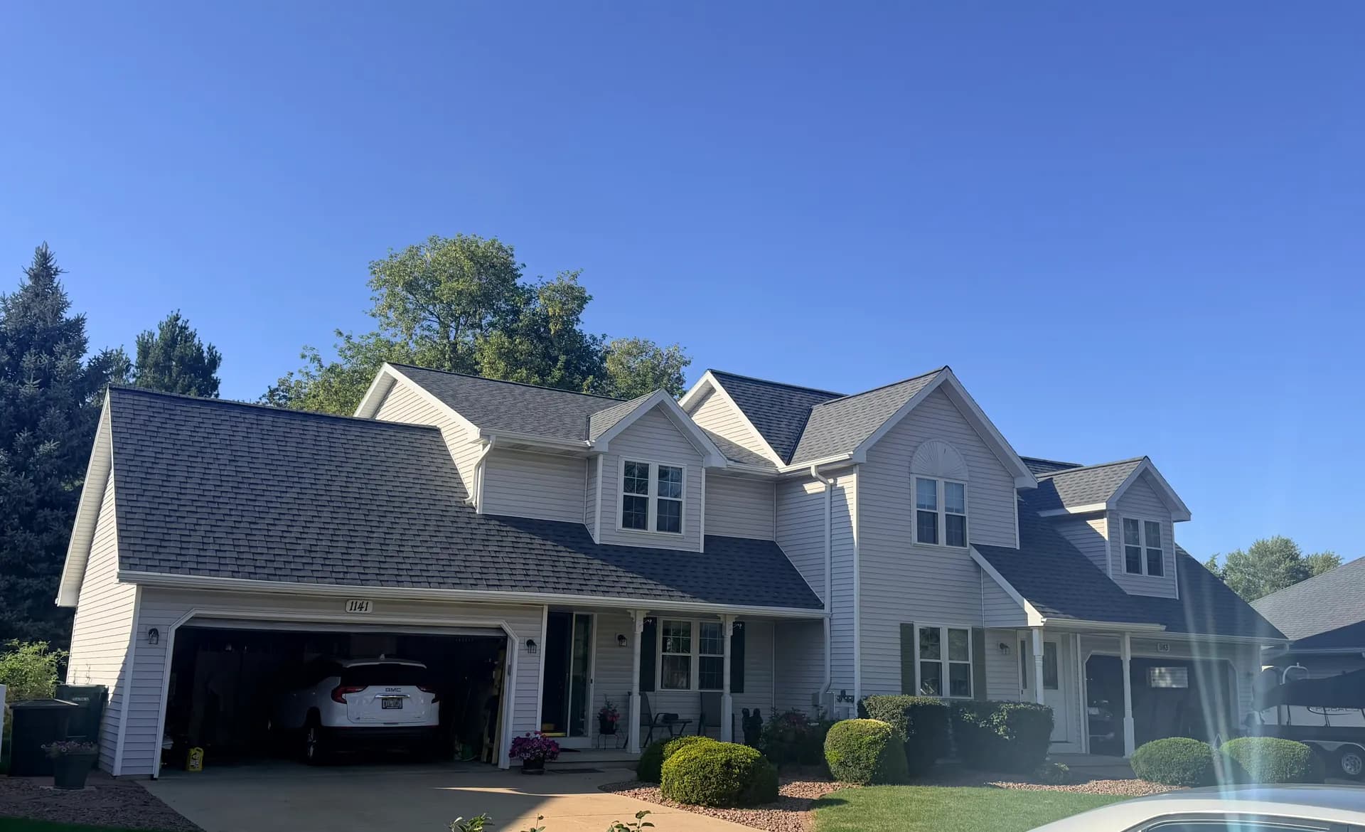 Two-story home with a completed asphalt shingle roof replacement in west Green Bay WI