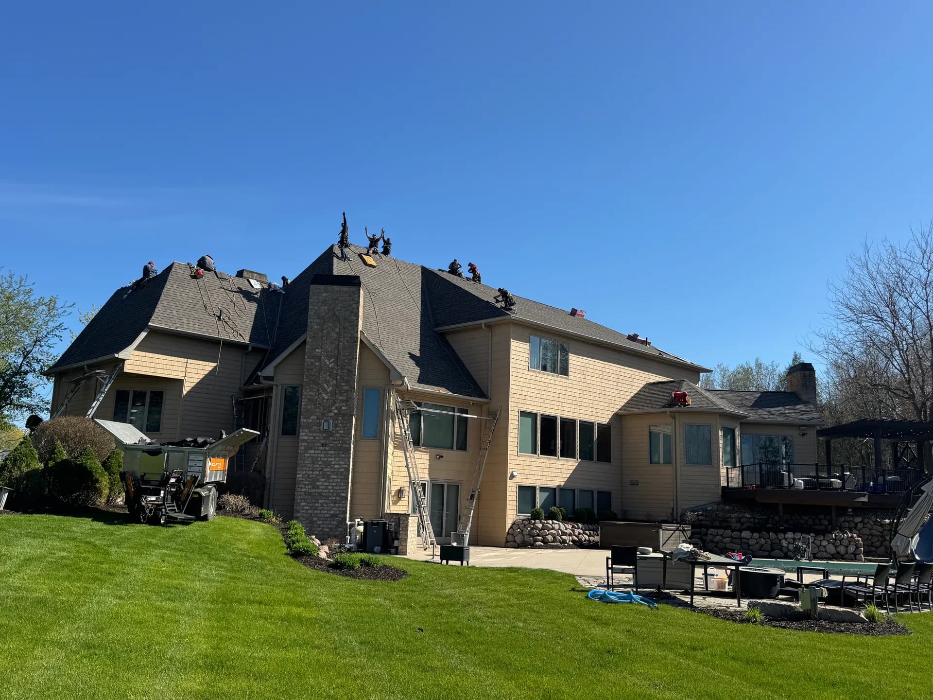 Pierce Roofing crew installing new shingles on a large home in Green Bay Wisconsin