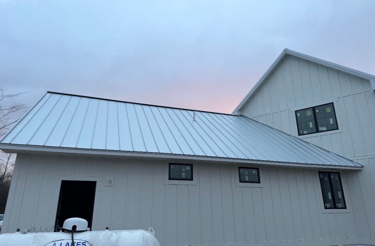 New construction home in Northeast Wisconsin with a charcoal standing seam metal roof installed by Pierce Roofing
